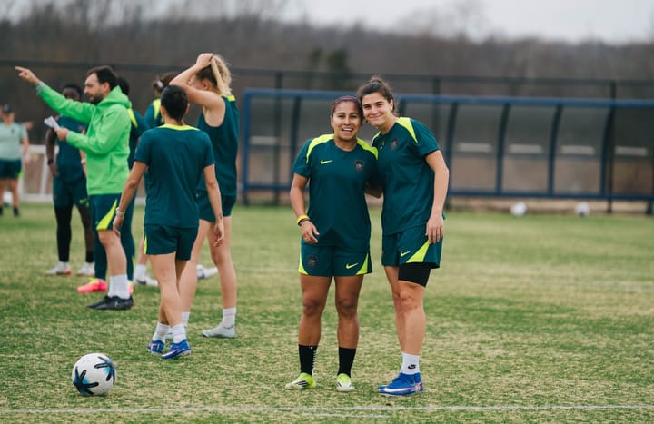 A photo of Leicy Santos and Sofia Cantore smiling at a Washington Spirit training session.