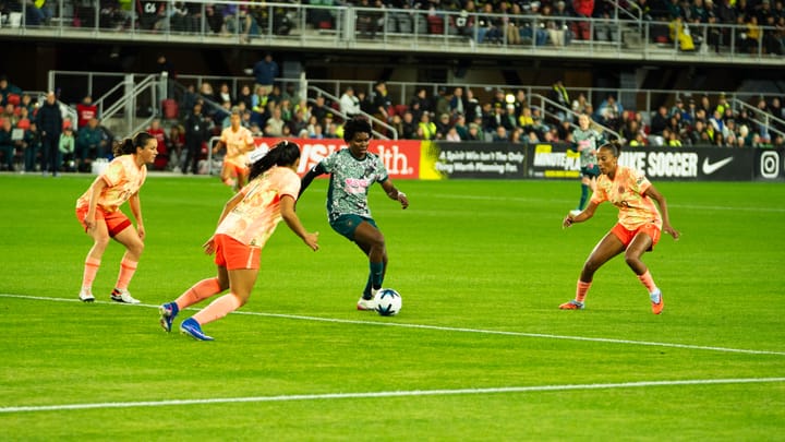 A photo of Gift Monday surrounded by Jessie Fleming, Reyna Reyes, and M.A. Vignola during the Washington Spirit-Portland Thorns NWSL match.