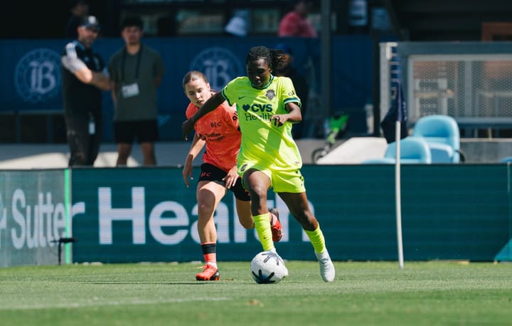 Rosemonde Kouassi dribbles past Anouk Denton during the Washington Spirit's game against Bay FC.
